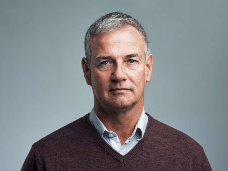 white male in shirt and jumper 